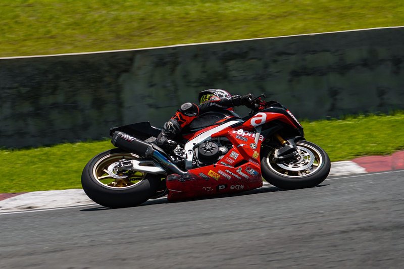 High-speed motorcycle race action shot on a circuit in Batangas, Philippines.