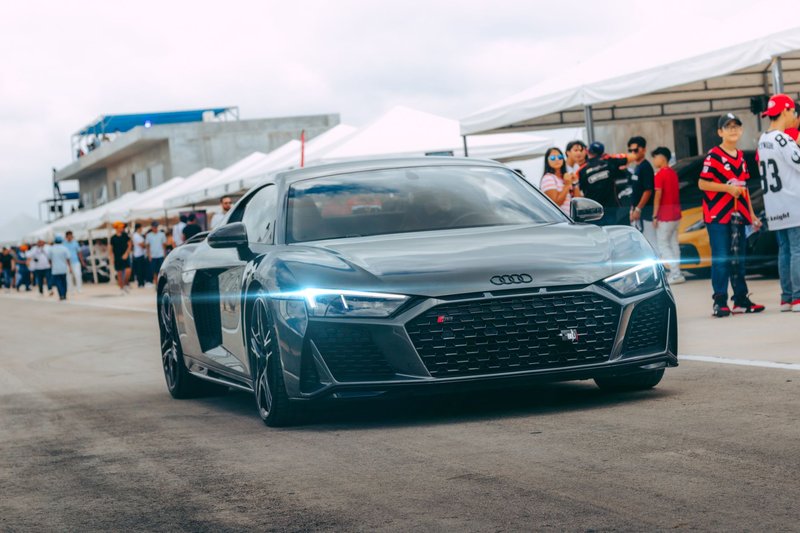 Sleek Audi R8 showcased at an outdoor automotive event with spectators.