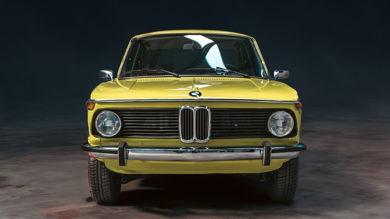 Front view of a vintage BMW car captured in a studio setting, showcasing its sleek design.