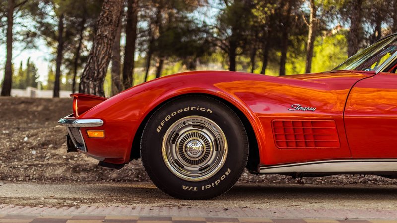 Close-up of a classic red Chevrolet Corvette Stingray, showcasing vintage charm.