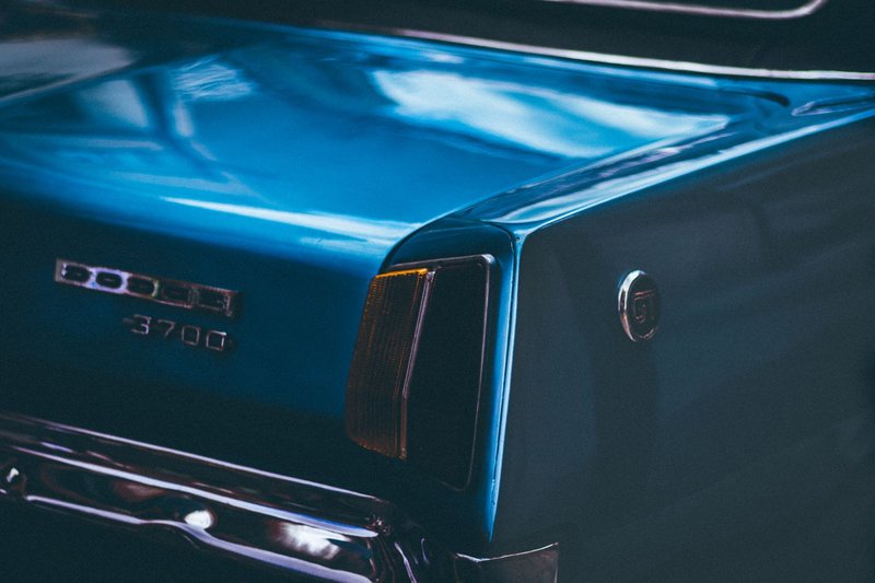 Close-up shot of a blue vintage Dodge car in Barcelona, showcasing its sleek rear design.