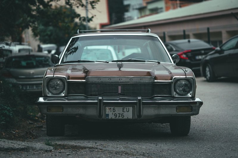 Front view of a vintage Dodge Aspen parked on a city street, evoking nostalgia and classic automotive style.