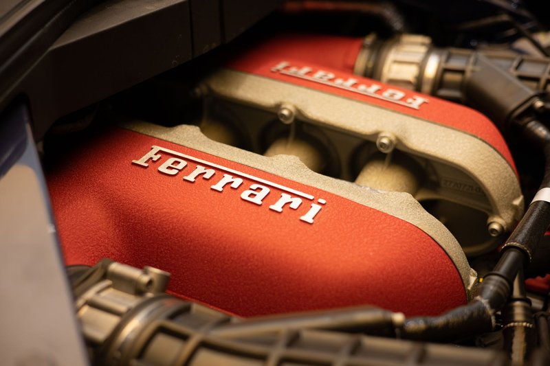 Detailed close-up of a Ferrari engine showcasing luxury and performance.