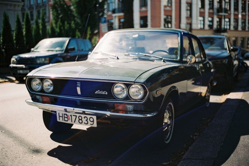 Retro car parked on a sunny city street, capturing classic automotive charm and vintage style.