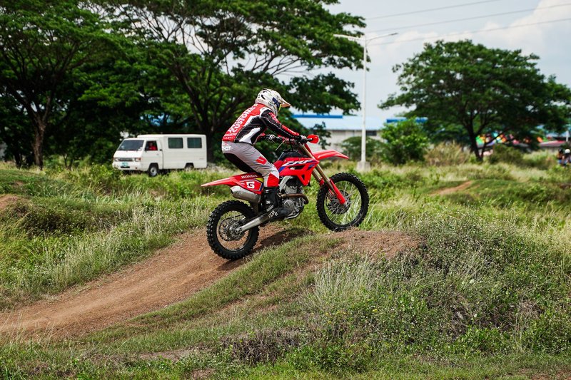 Action shot of a dirt biker riding through a trail in Bulakan, Philippines.