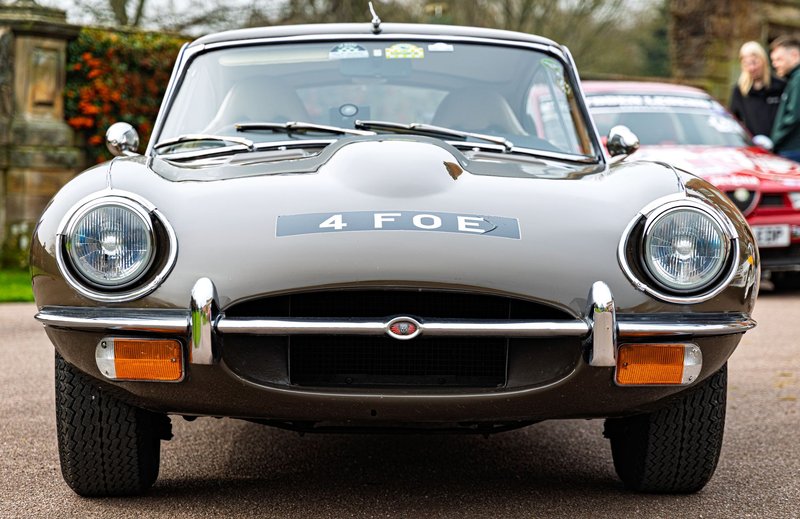 Front view of iconic Jaguar E-Type at motorsport rally in Weston Park. Perfect for classic car enthusiasts.