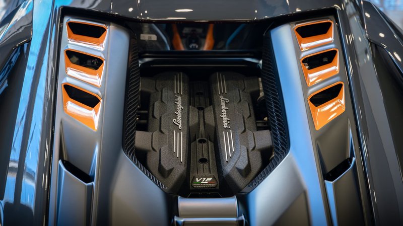 Detailed image of a Lamborghini V12 engine highlighting the sleek design and craftsmanship.