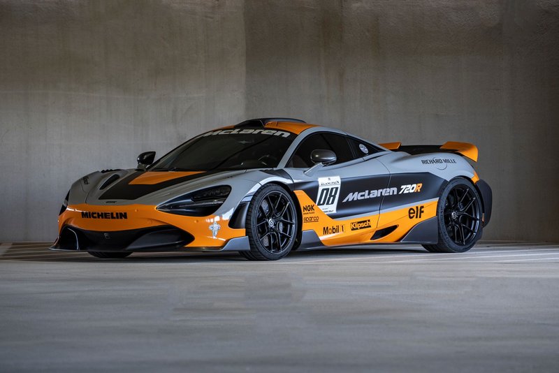 High-performance McLaren 720S sports car parked in a concrete garage.