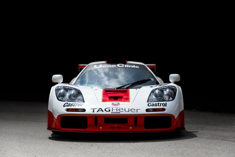 Front view of a classic McLaren racing car with sponsor logos on display.