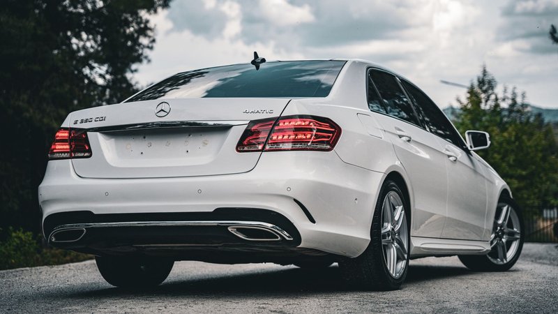 Elegant white Mercedes-Benz E-Class parked outdoors showcasing luxury and sophistication.