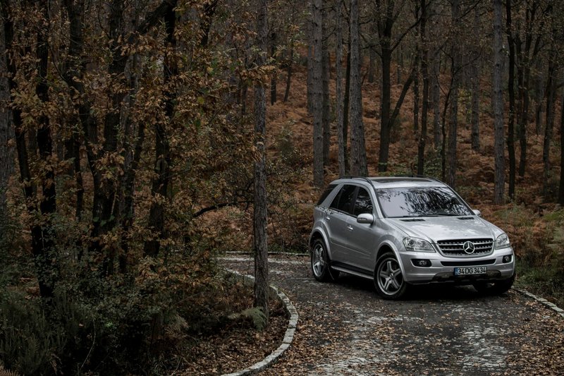 A Mercedes-Benz SUV parked on a scenic forest path in autumn, İstanbul, Turkey.