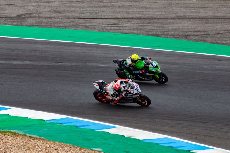 Motorcyclists racing on a track during a thrilling motorsport event in Portugal.