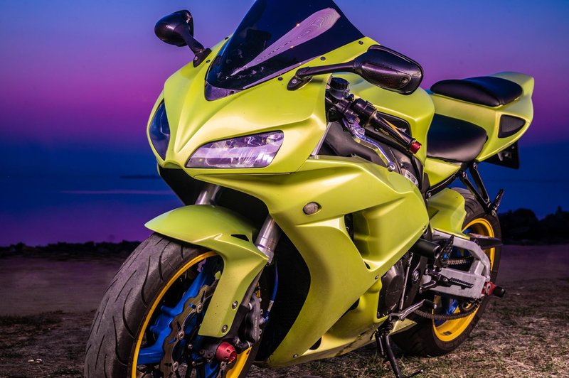 A striking neon green motorcycle parked against a stunning twilight backdrop, perfect for automotive enthusiasts.