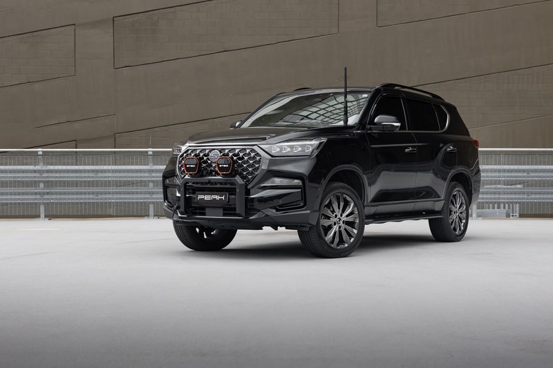 Stylish black SUV in a modern urban parking area, showcasing sleek design.