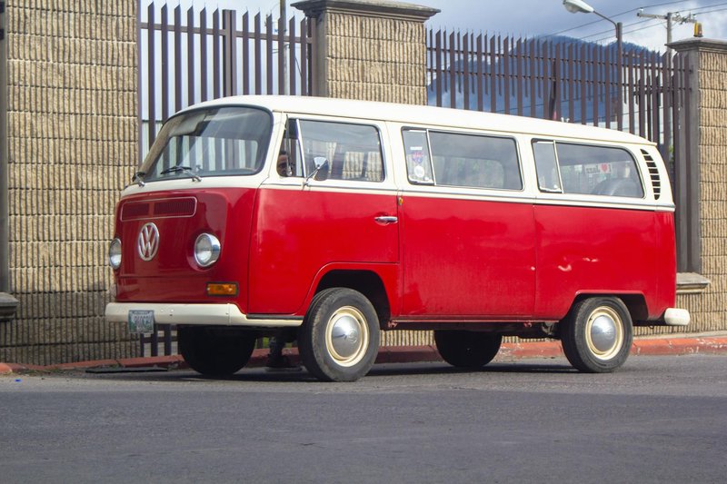 Vintage Volkswagen van parked on an urban street during the day.