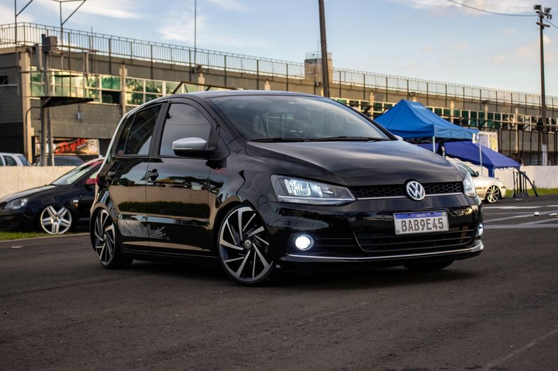 A sleek Volkswagen hatchback parked outdoors, showcasing its design on an asphalt road.
