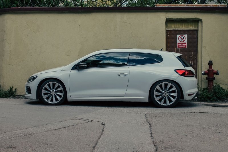 Side view of a white Volkswagen Scirocco parked on a street in Bursa, Türkiye.