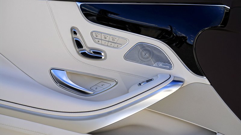 Close-up view of a luxury car door interior showcasing sleek design and technology.