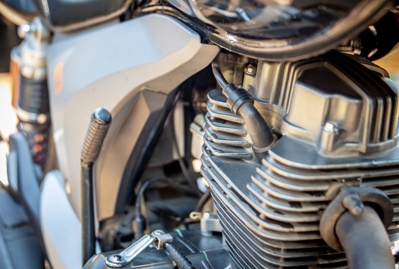 Detailed view of motorcycle engine, showcasing intricate mechanical parts. Ideal for automotive enthusiasts.