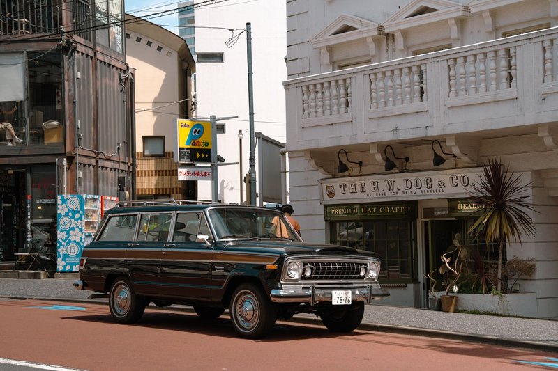 Classic SUV parked in front of a retro store in Tokyo, Japan. Perfect for vintage and urban themes.