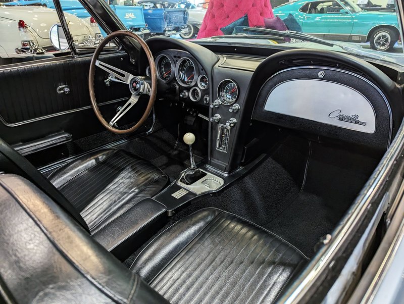 Detailed view of a vintage Chevrolet Corvette interior with classic design elements.