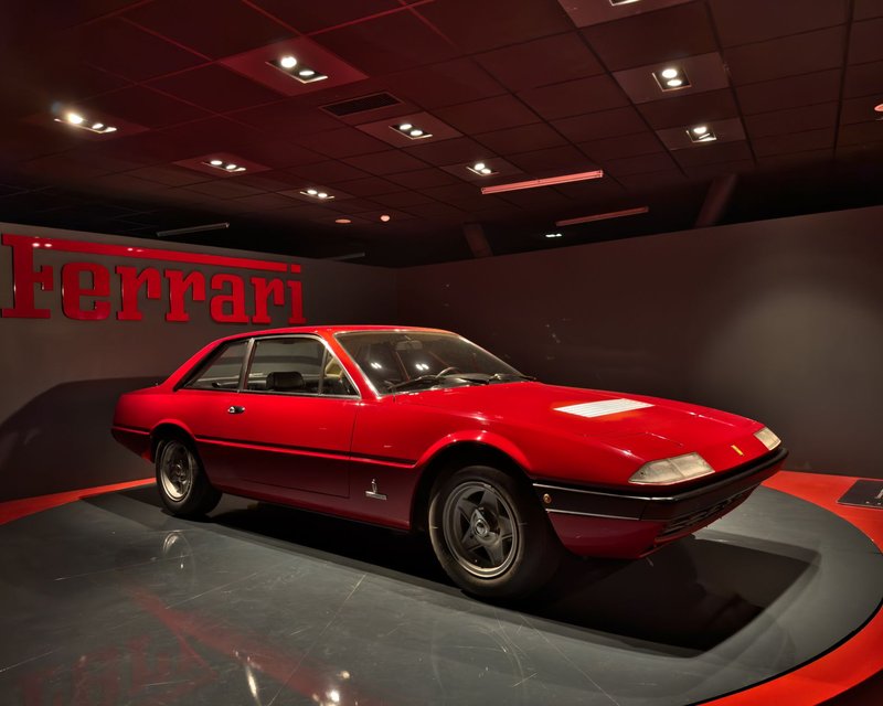 Classic red Ferrari showcased at an automotive museum in Turin, Italy. Iconic Italian design.