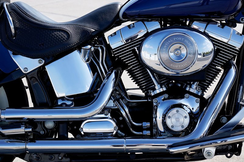 Detailed view of a chrome motorcycle engine showcasing its intricate design and shine.