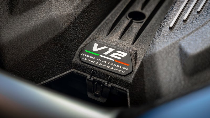 Detailed close-up of a V12 engine showcasing intricate design with label and texture highlights.