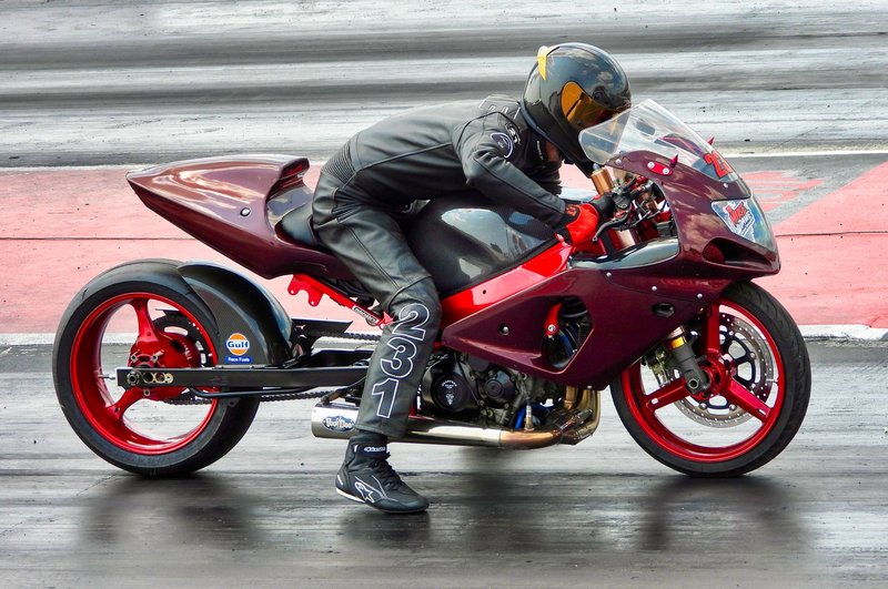 Motorcyclist racing down drag strip in Cayuga, Ontario.