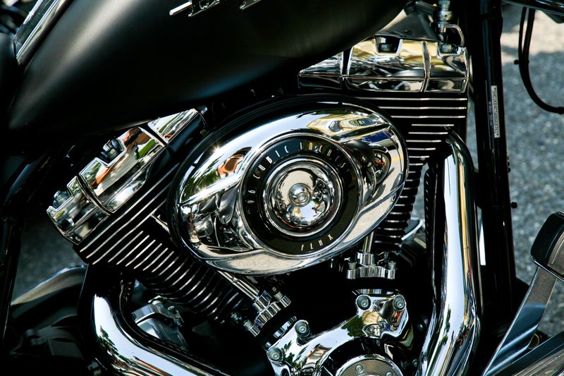 Detailed close-up of a chrome motorcycle engine showcasing the intricate design and shiny finish.