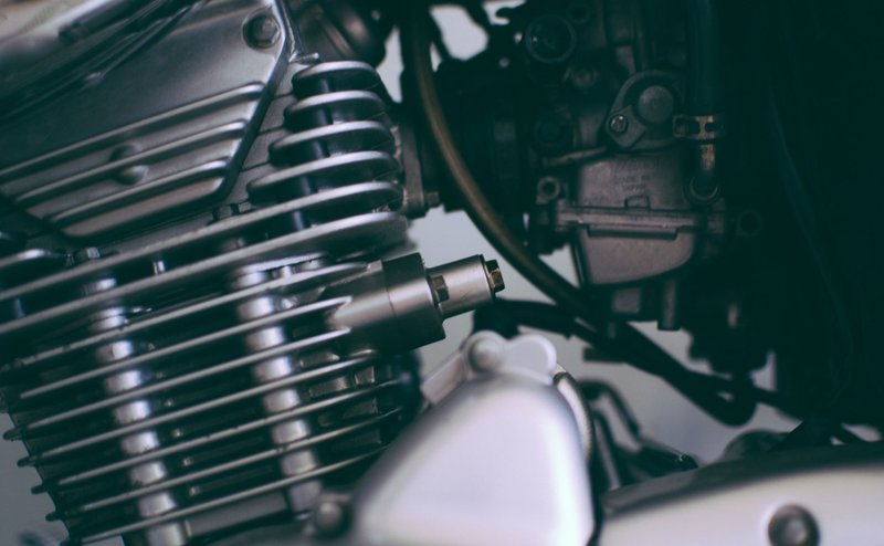 Detailed close-up of a shiny motorcycle engine showcasing metal components.