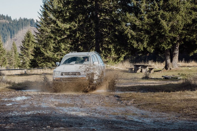 Toyota 4Runner on a muddy off-road trail in Veneto, Italy, showcasing overlanding spirit.