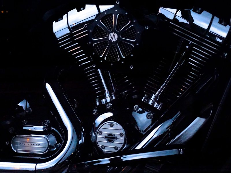 Detailed view of a chrome Harley Davidson motorcycle engine with sleek metal design.