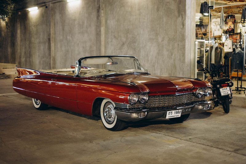 A vintage red convertible car parked in a Bangkok garage, capturing a classic automotive style.