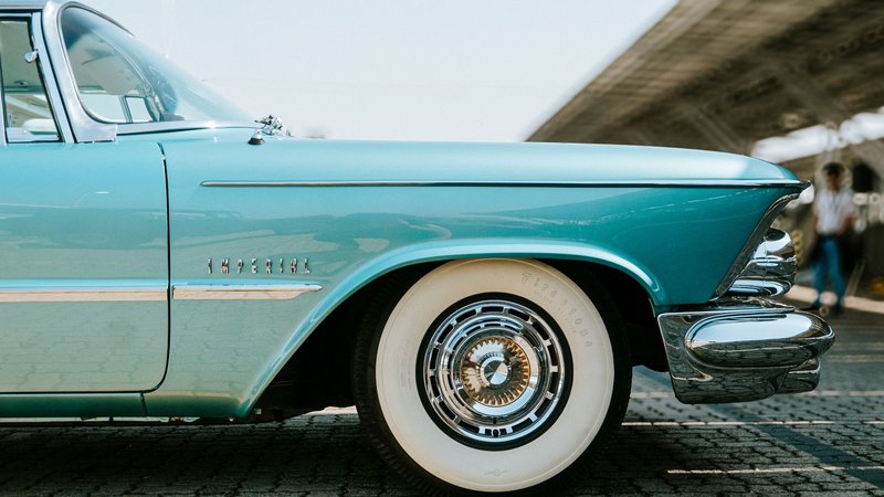 Close-up of a classic blue Chrysler Imperial car parked outdoors showcasing its elegant design.