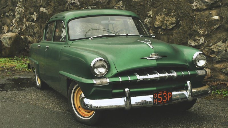 A classic restored 1953 green Plymouth car parked outdoors in Boonton, New Jersey.