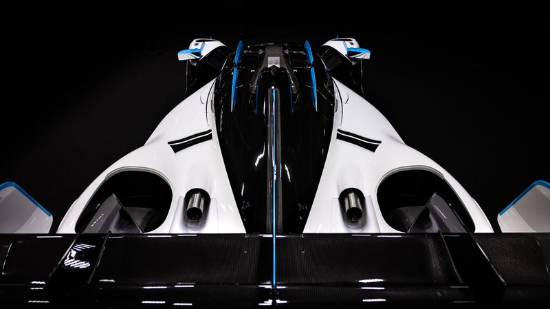 A stunning top-down view of a sleek, aerodynamic race car with black, white, and blue accents.