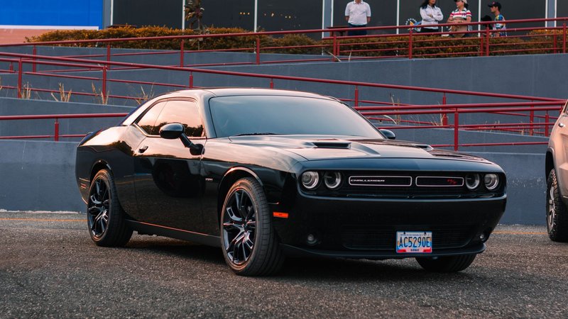 A stylish black Dodge Challenger parked outdoors, perfect for automotive enthusiasts.