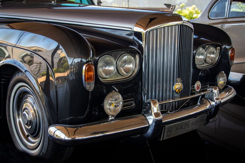 Close-up of a classic black Bentley showcasing luxury and vintage appeal.