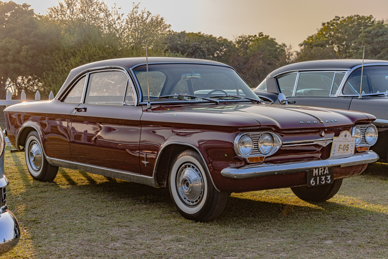 Classic Chevrolet Corvair displayed at an outdoor car show in Gurugram, India.