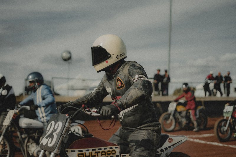 Motorcycle racers in action during an exhilarating dirt track event, showcasing speed and skill.