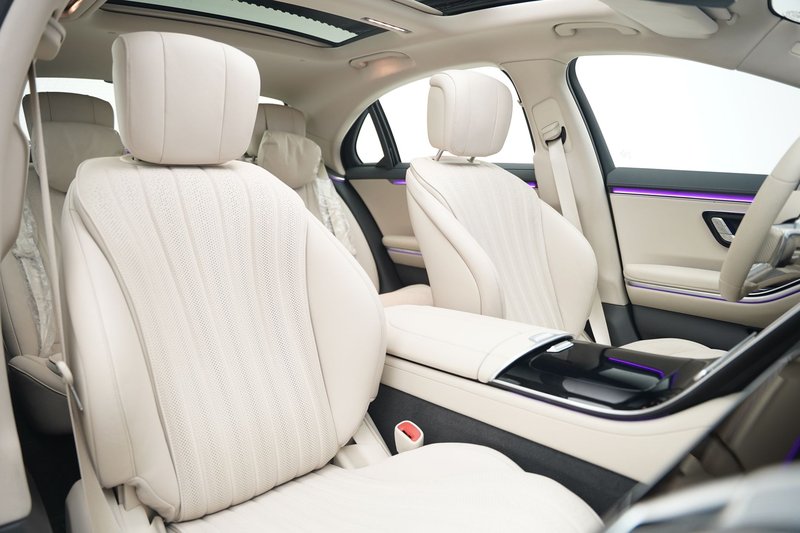 Explore the spacious and elegant white leather interior of a luxury vehicle.