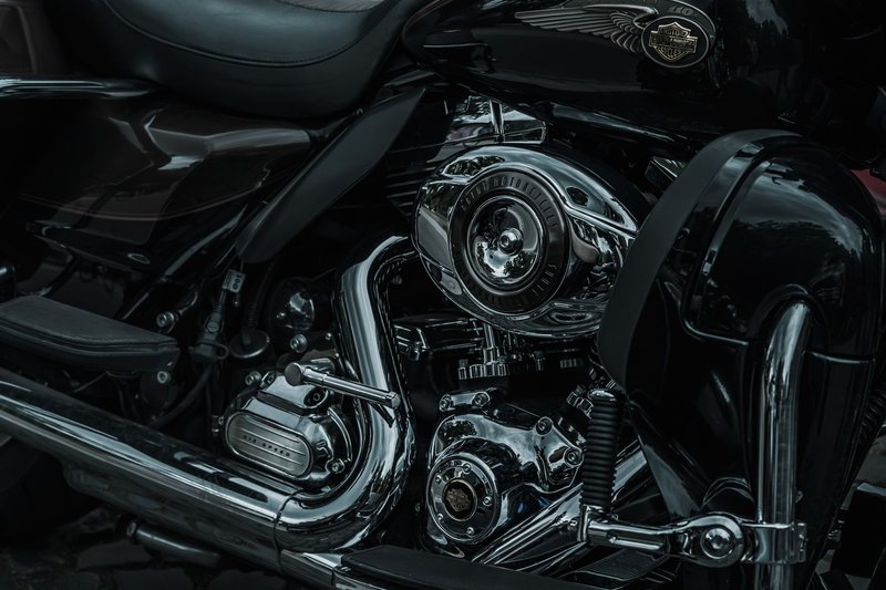 Detailed closeup of a shiny Harley Davidson motorcycle engine showcasing chrome parts.