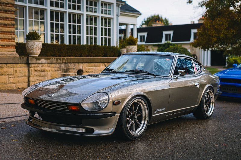 Silver classic sports car parked outdoors showing elegance and style.