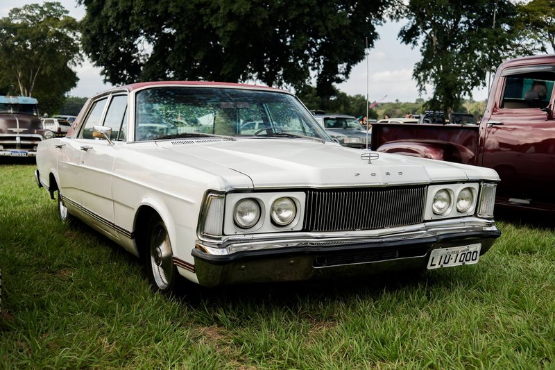 Vintage Ford Galaxie car showcased outdoors surrounded by trees, perfect for automobile enthusiasts.