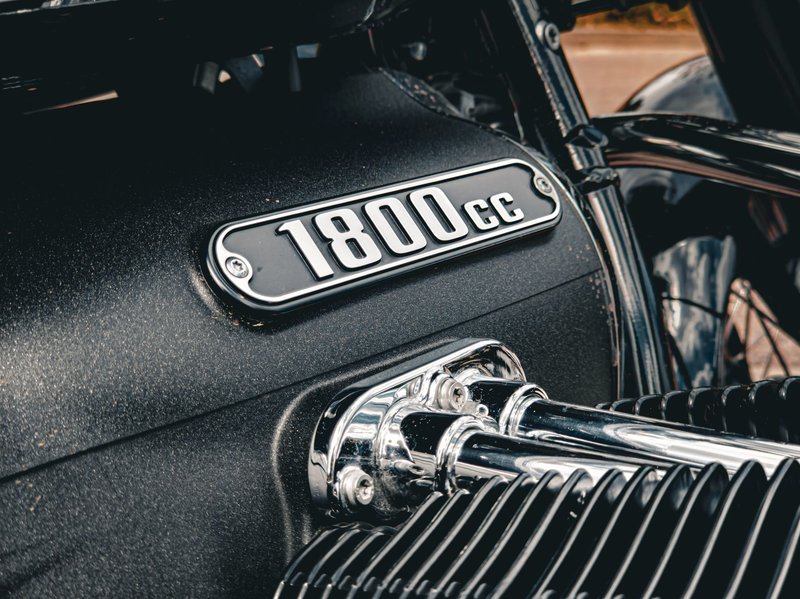 Detailed view of a chrome motorcycle engine showcasing the 1800cc plaque in outdoor settings.