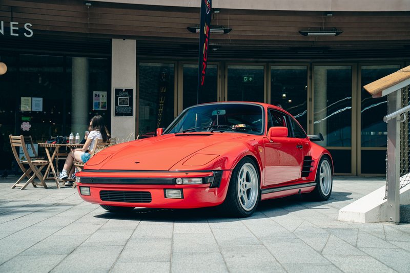 Classic red sports car parked outdoors in Southampton, England with a cafe in the background.