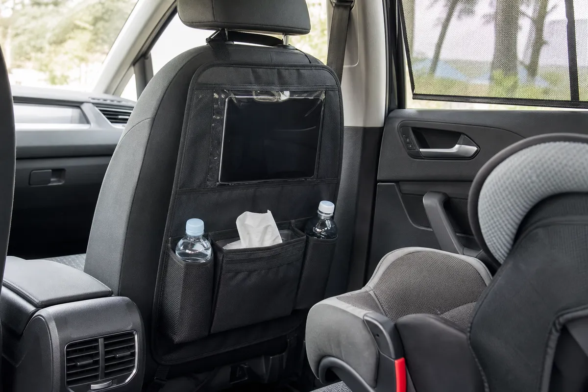 A backseat organizer hanging from the back of a front seat